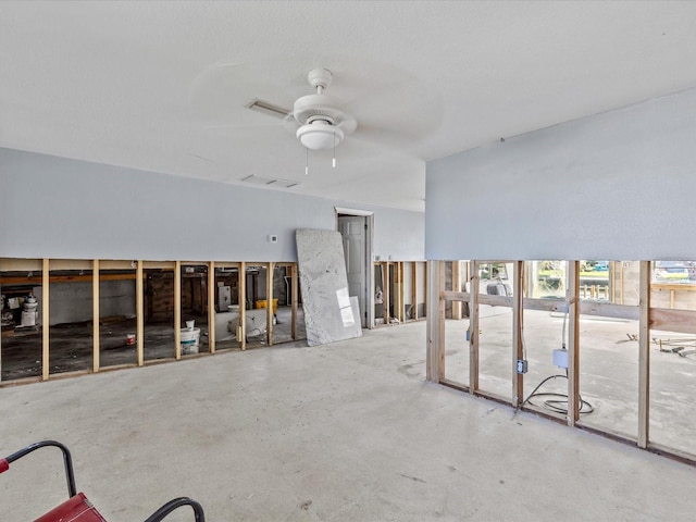 miscellaneous room with ceiling fan and concrete floors