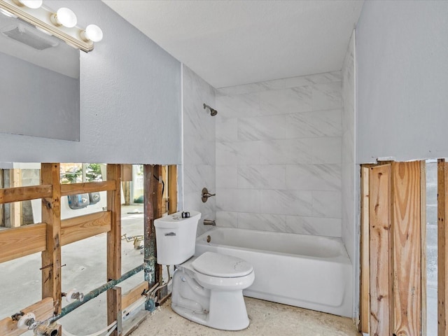 bathroom featuring toilet and tiled shower / bath