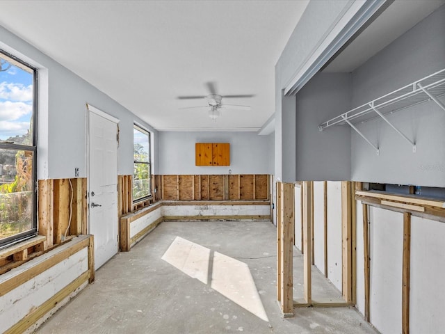 interior space featuring ceiling fan and a wealth of natural light