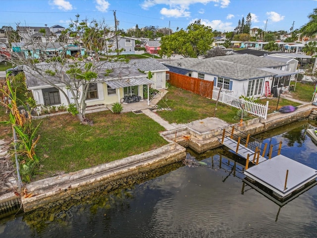 exterior space featuring a lawn, a water view, and a patio