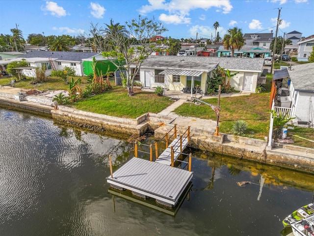 dock area with a water view and a lawn