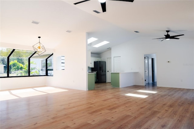 unfurnished living room featuring light wood-type flooring, high vaulted ceiling, and ceiling fan