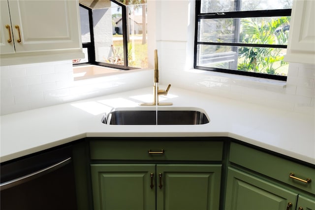 kitchen featuring tasteful backsplash, sink, white cabinets, and green cabinetry