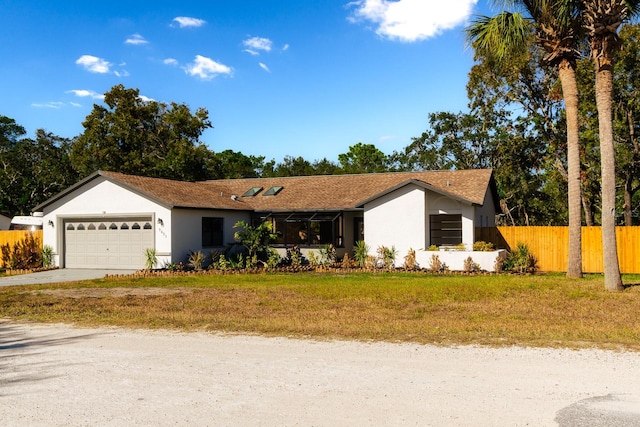 ranch-style home with a garage and a front yard