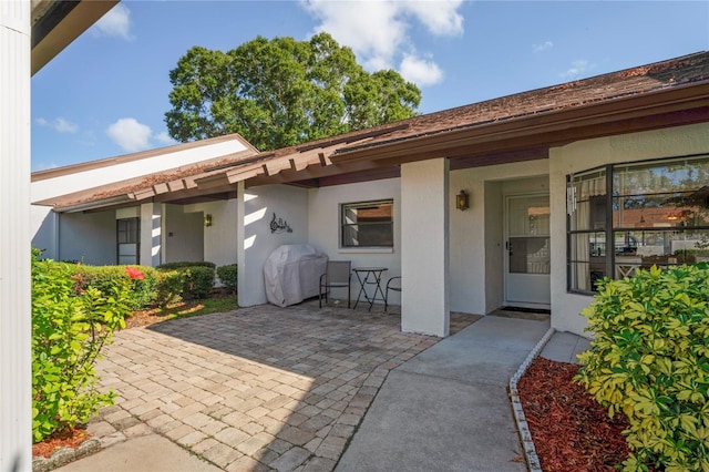 entrance to property with a patio