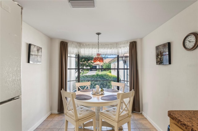 dining area featuring light tile patterned flooring