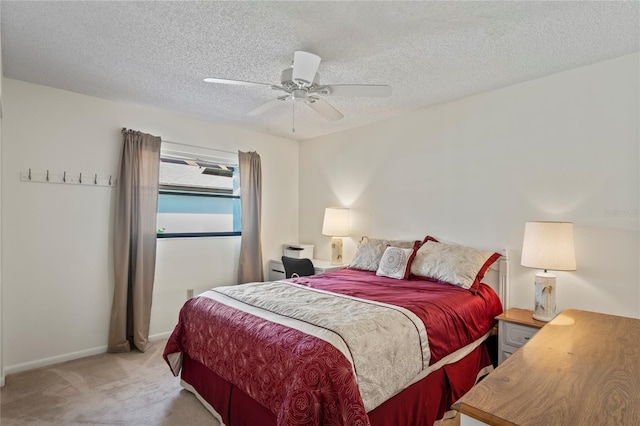 bedroom with light carpet, a textured ceiling, and ceiling fan