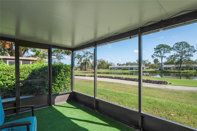 unfurnished sunroom with a water view