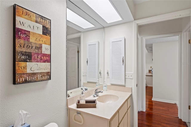 bathroom with vanity and hardwood / wood-style flooring