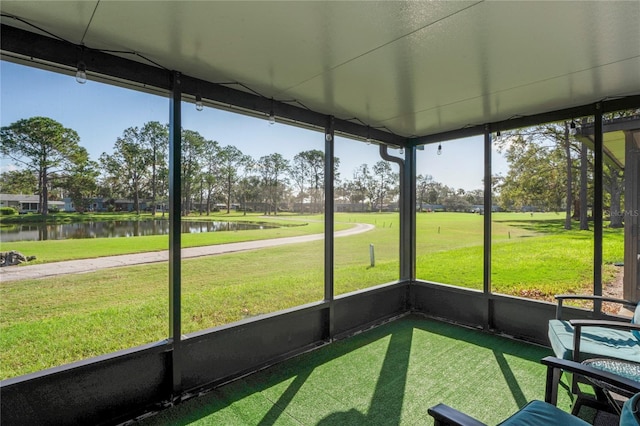 unfurnished sunroom featuring a water view