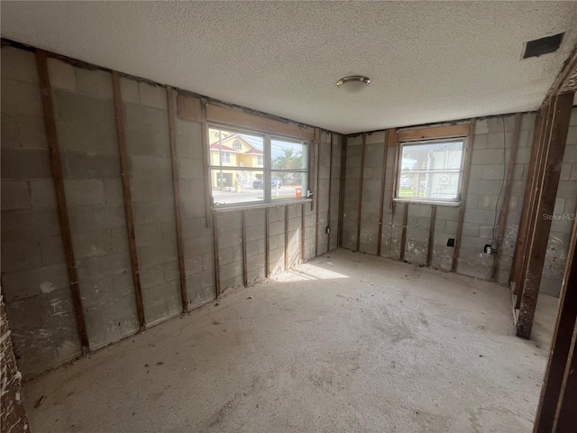 basement featuring a textured ceiling