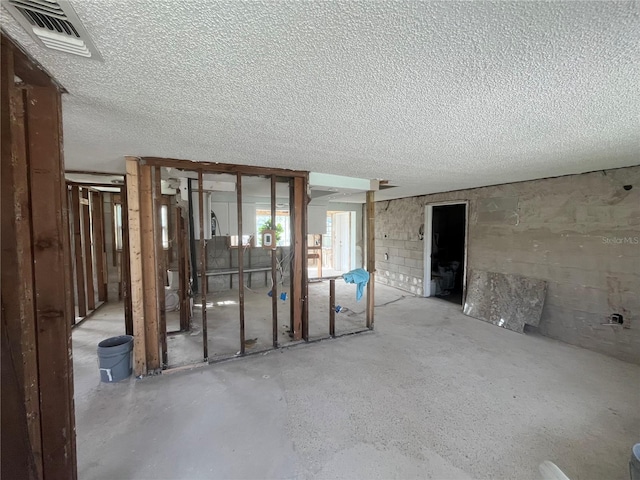 unfurnished room with visible vents and a textured ceiling