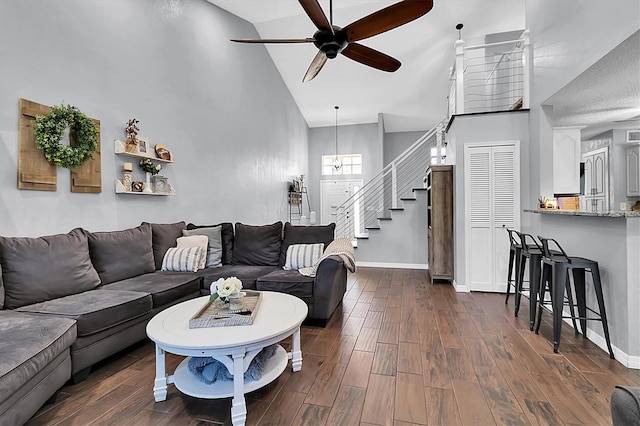 living room featuring high vaulted ceiling, ceiling fan, and dark wood-type flooring