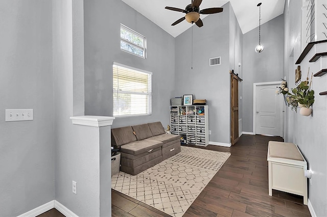 living room with a barn door, ceiling fan, high vaulted ceiling, and dark wood-type flooring