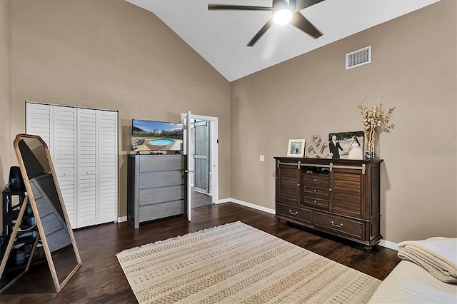 bedroom with a closet, high vaulted ceiling, ceiling fan, and dark wood-type flooring