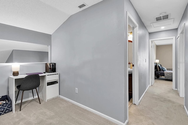 office space featuring light colored carpet and vaulted ceiling