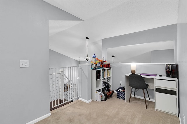 office area featuring light colored carpet and vaulted ceiling