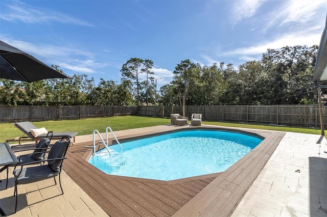 view of swimming pool with a deck and a yard