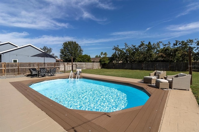 view of swimming pool with a lawn