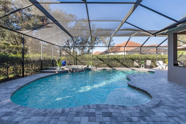 view of pool featuring a lanai, a patio area, and an in ground hot tub