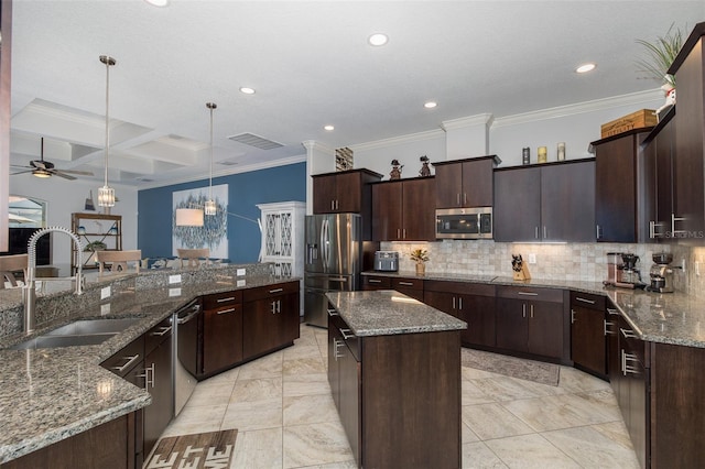 kitchen featuring dark brown cabinetry, stainless steel appliances, coffered ceiling, decorative light fixtures, and a kitchen island