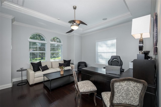 office area with dark hardwood / wood-style floors, ceiling fan, ornamental molding, and a tray ceiling