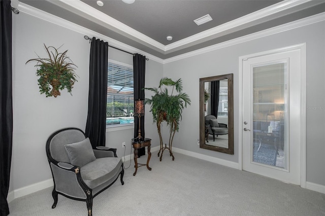 living area featuring light carpet, a raised ceiling, and crown molding