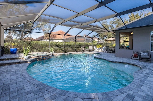 view of swimming pool with an in ground hot tub, a patio, pool water feature, and a lanai