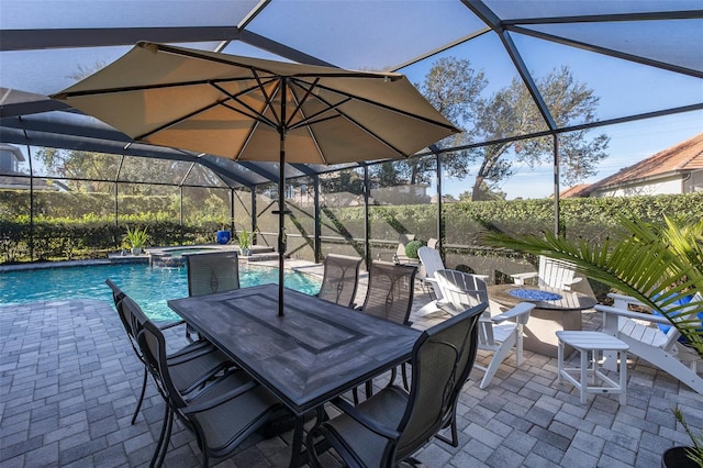 view of patio / terrace with a swimming pool with hot tub and an outdoor fire pit