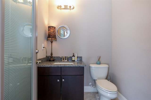 bathroom featuring tile patterned floors, vanity, and toilet