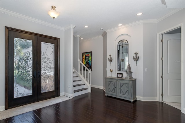 entrance foyer with french doors, dark hardwood / wood-style floors, and ornamental molding