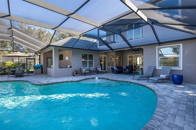 view of swimming pool with a patio area and a lanai