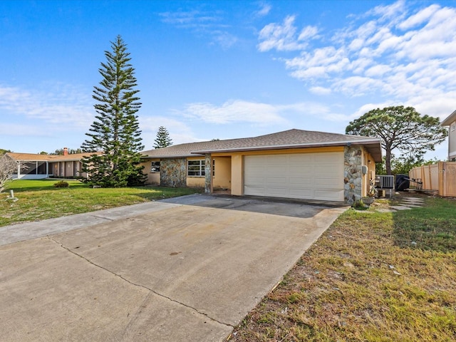 single story home with a front yard, a garage, and cooling unit