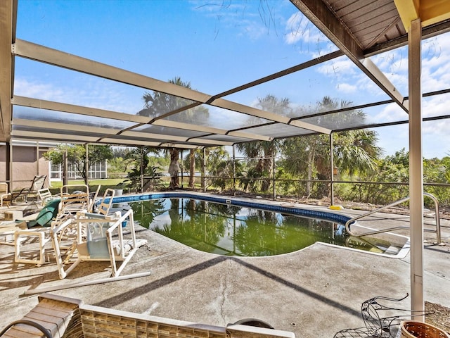 view of swimming pool with glass enclosure and a patio area