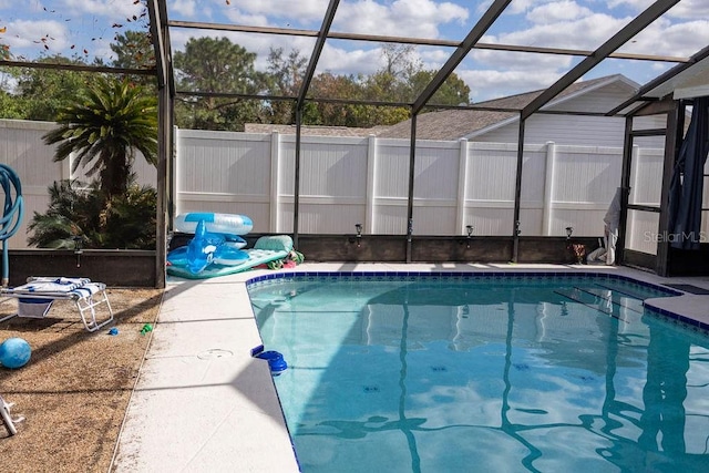 view of pool with glass enclosure