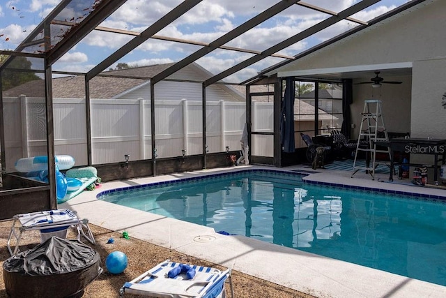 view of pool featuring a lanai and ceiling fan