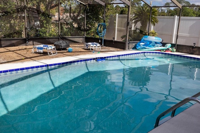 view of pool featuring glass enclosure