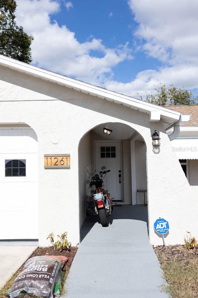 view of exterior entry with a garage