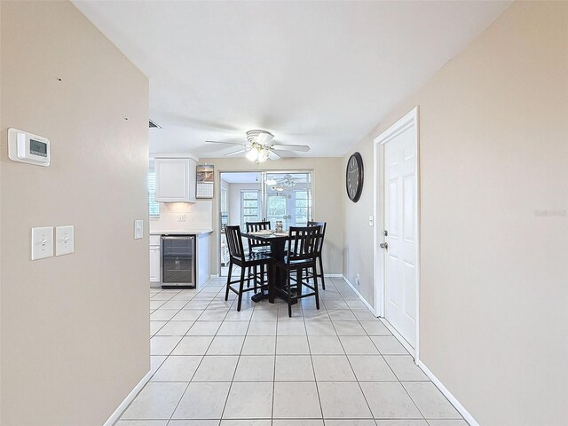 tiled dining room with ceiling fan and beverage cooler