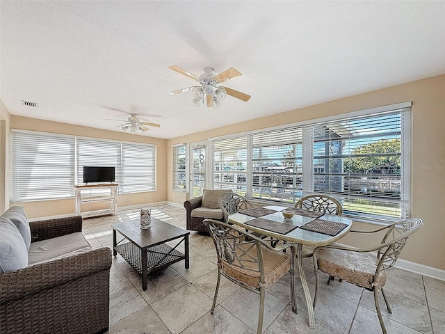 sunroom with ceiling fan and a wealth of natural light