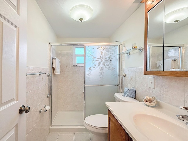 bathroom featuring toilet, tile patterned flooring, tile walls, and walk in shower