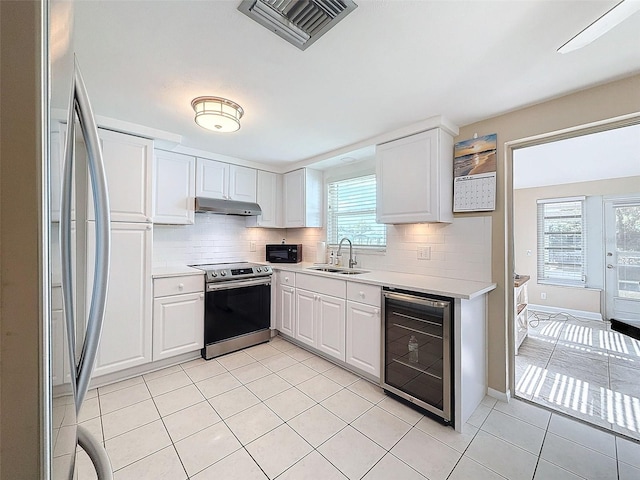 kitchen with white cabinetry, wine cooler, decorative backsplash, sink, and stainless steel electric range