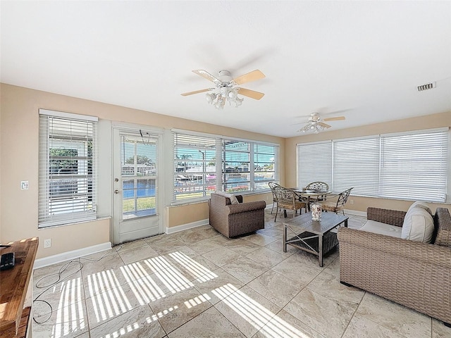 living room featuring ceiling fan and light tile patterned floors