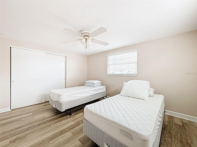 bedroom featuring ceiling fan and light hardwood / wood-style flooring