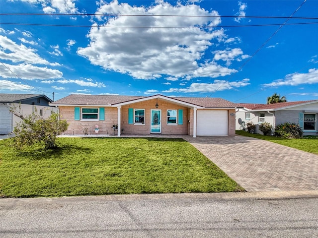 ranch-style house featuring a front lawn and a garage