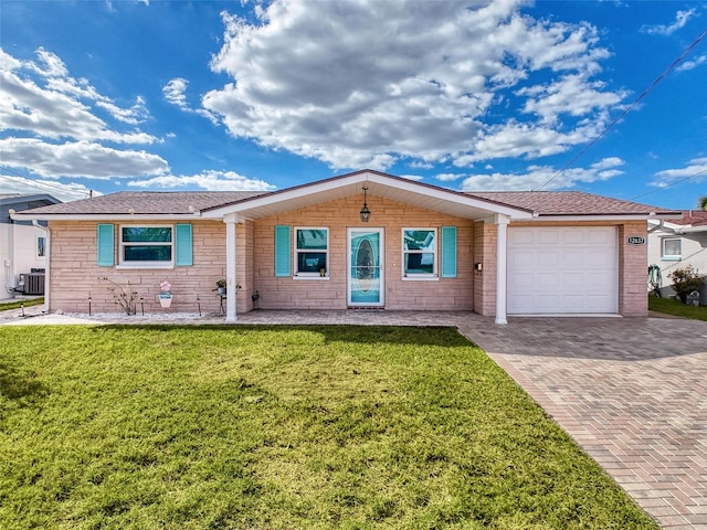 single story home with a garage, cooling unit, and a front lawn