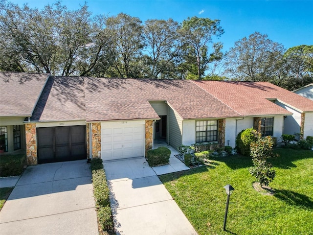 ranch-style house featuring a garage and a front lawn