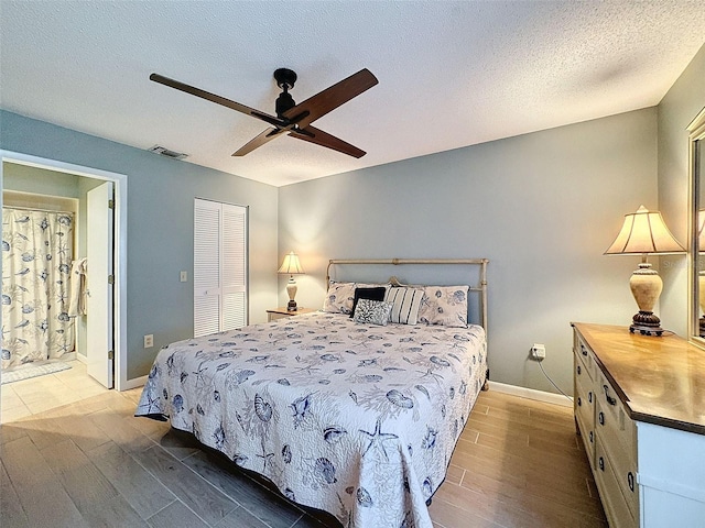 bedroom with ceiling fan, a closet, a textured ceiling, and light wood-type flooring