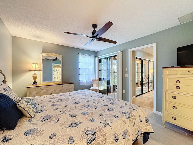 bedroom featuring ceiling fan, access to exterior, light wood-type flooring, and a textured ceiling