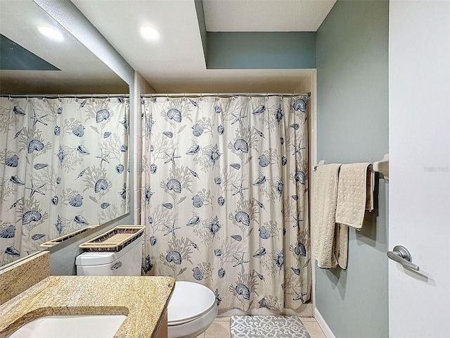 bathroom featuring tile patterned flooring, vanity, and toilet